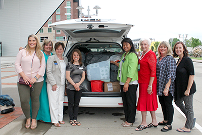 KEHA members load donated items for transportation to the Center for Couragous Kids