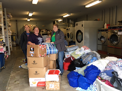 The donated quilts and pillowcases arrive at the Center for Courageous Kids laundry facility